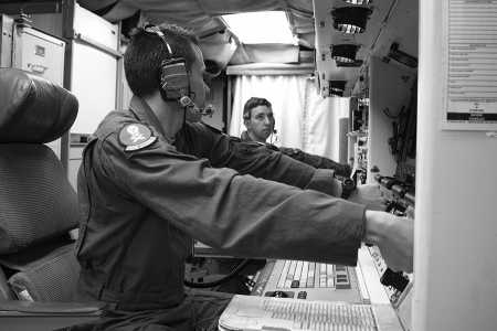Second Lt. Chris Davis, 321st Missile Squadron deputy missile combat crew commander, and 1st Lt. Paul Lee, 321st Missile Squadron missile combat crew commander, simulate key turns of the Minuteman III weapon system during a Simulated Electronic Launch-Minuteman test inside the launch control center at a missile alert facility in  the 90th Missile Wing's missile complex in Nebraska, April 11, 2017.  (Photo credit: Staff Sgt. Christopher Ruano/DVIDS)