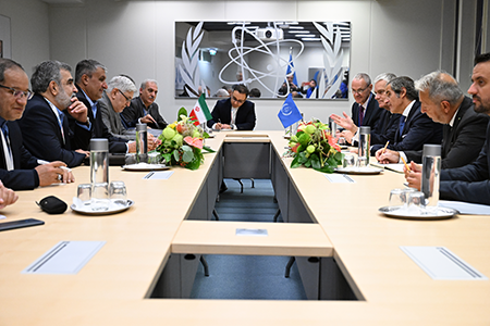 Rafael Mariano Grossi (Right, Center), director-general of the International Atomic Energy Agency, meets Mohammad Eslami (Center, Left), head of the Atomic Energy Organization of Iran, at IAEA headquarters in Vienna in September. Grossi is pressing Iran to allow the resumption of more rigorous monitoring of its nuclear program. (Photo by Dean Calma / IAEA)