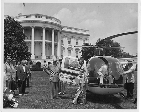 U.S. Navy Captain Evan Aurand (L) holds an an early version of the president’s emergency satchel, later known as the nuclear football, as he accompanies President Dwight Eisenhower (C, with hand on hip) on the White House lawn during Operation Alert, a civil defense exercise, on July 12, 1957. (Photo courtesy of  the Dwight D. Eisenhower Presidential Library)